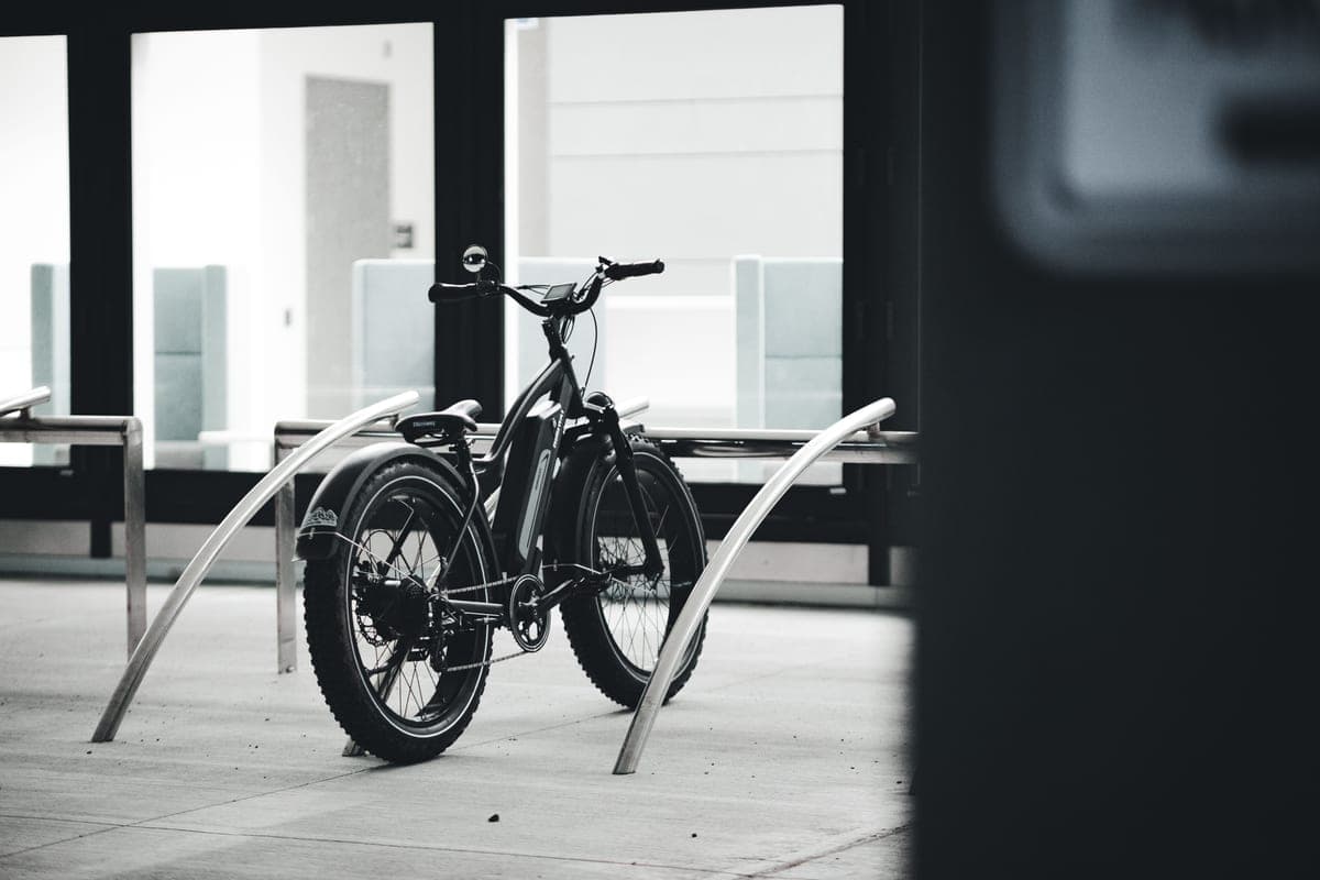 A city commuter bike parked against a wall